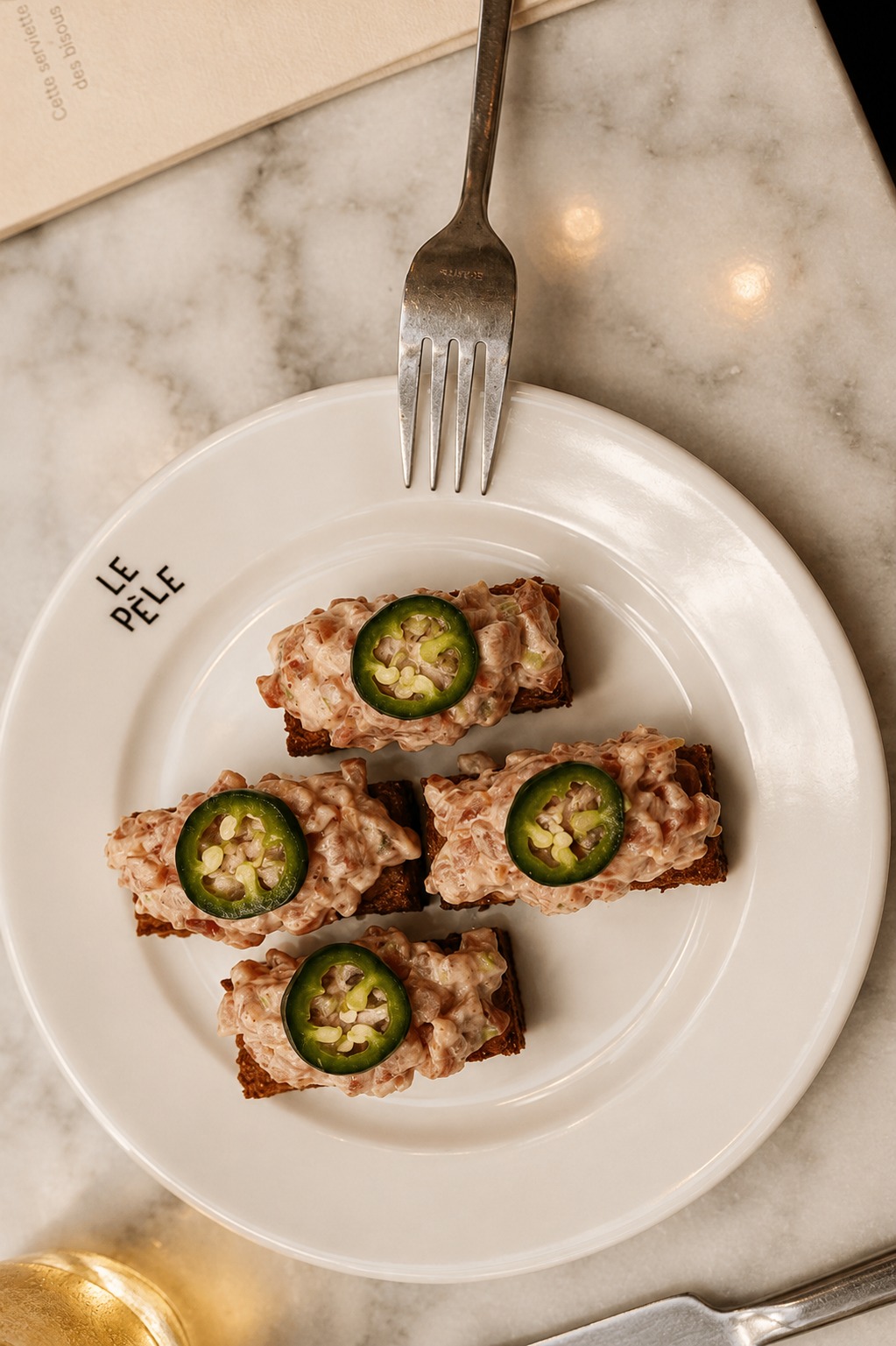 Four bites topped with slices of green chilli