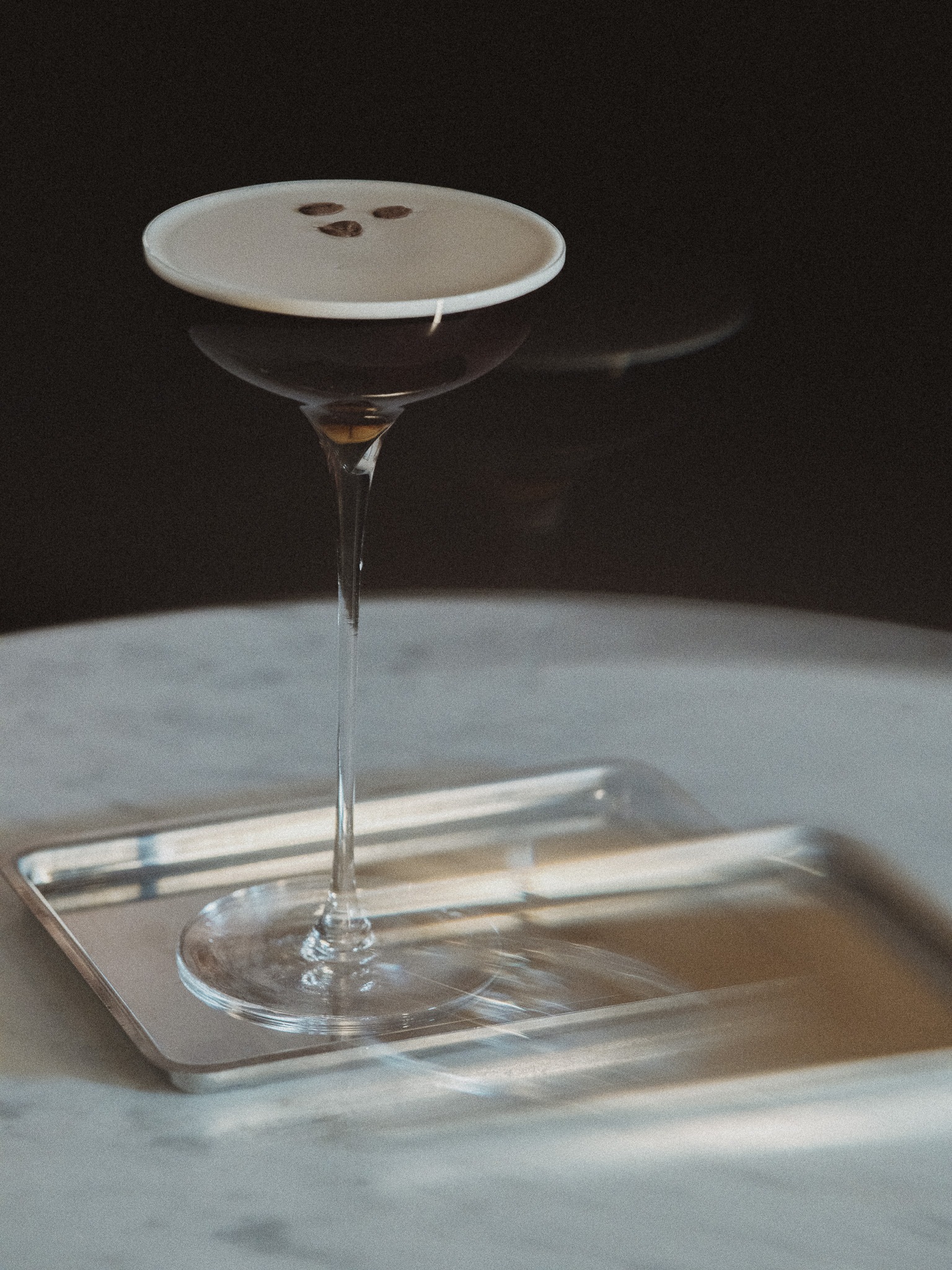 Romain’s cocktails — a coupe in the light.